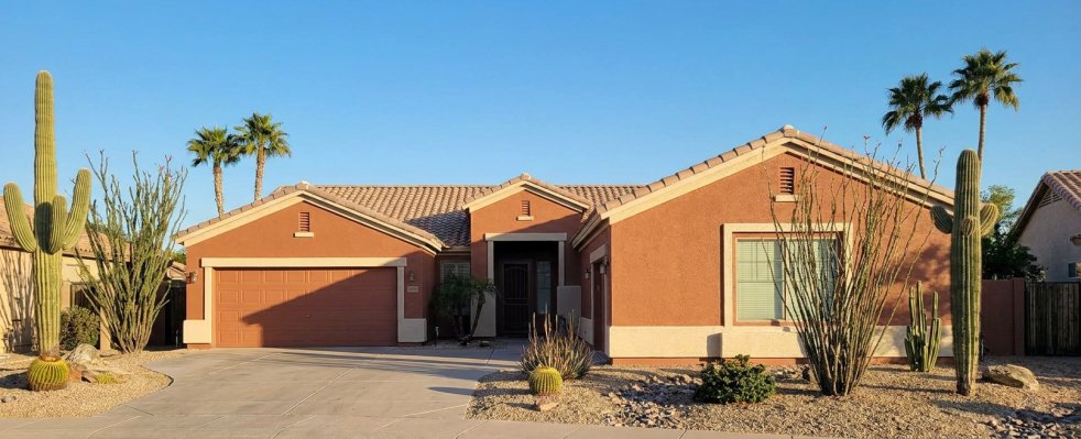 Stucco house in Mesa, AZ with desert landscaping and two-car garage